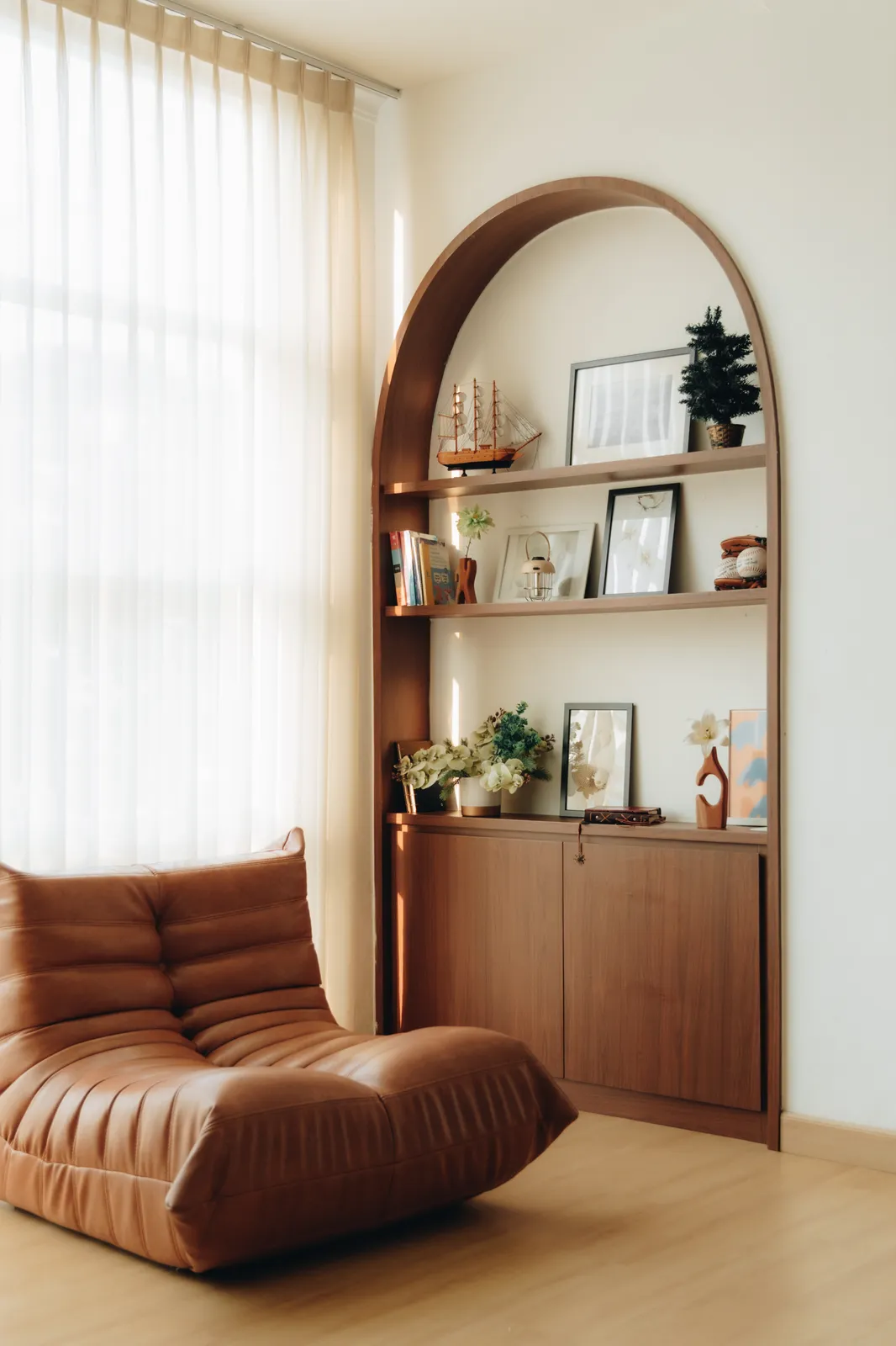 Sauropod Space: styled arch shelf with a tan leather sofa